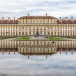 Die Ostfassade des Neuen Schloss Oberschleißheim spiegelt sich im Wasser der Kaskade im Schlosspark