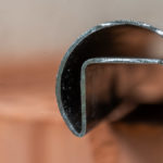 Edelstahlrohr mit eigebauter Nut, in die normalerweise Glas gesteckt wird