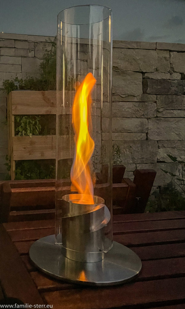 Tischfeuer von Höfats auf dem Gartentisch vor dem Kräuterregal