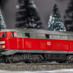 eine rote Diesellok der Serie 216 der DB fährt durch unseren Winterwald / Märklin H0 Modell